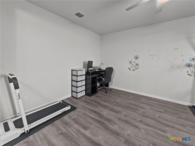 office area featuring a ceiling fan, dark wood-style flooring, visible vents, and baseboards