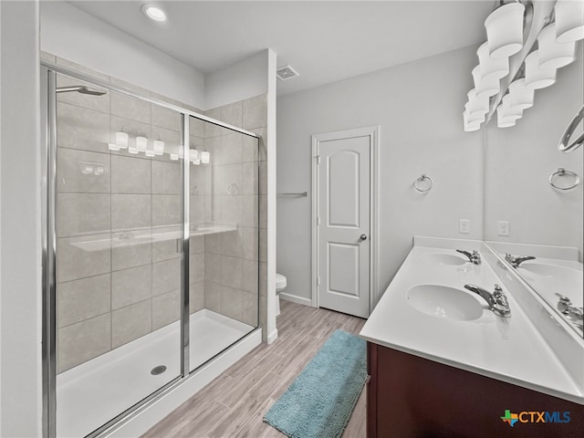 full bath featuring visible vents, double vanity, a sink, and toilet