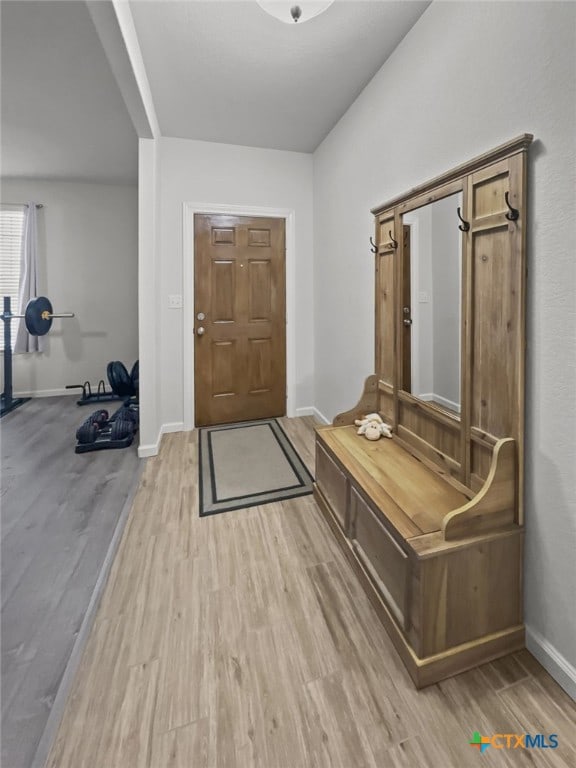 mudroom featuring light wood-type flooring and baseboards