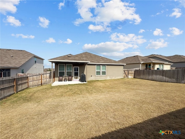 back of house with a yard, a fenced backyard, and a patio