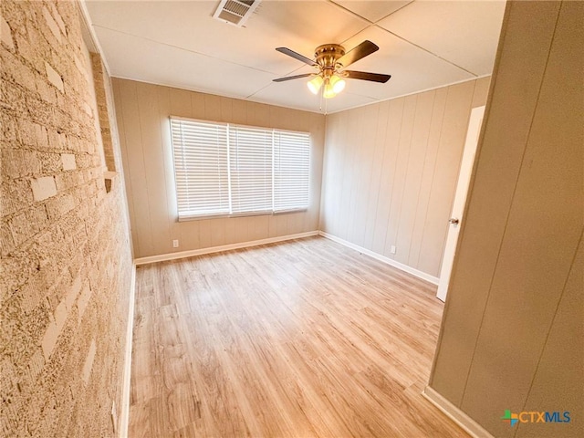 empty room featuring ceiling fan and light wood-type flooring