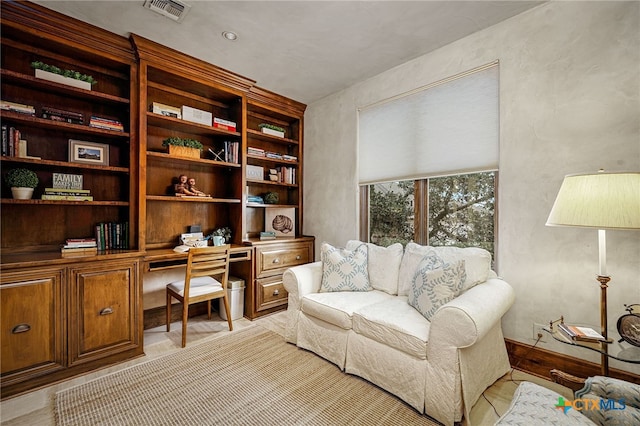 home office with built in desk and visible vents