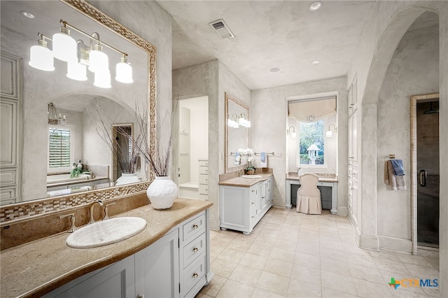 bathroom featuring two vanities, a sink, and visible vents