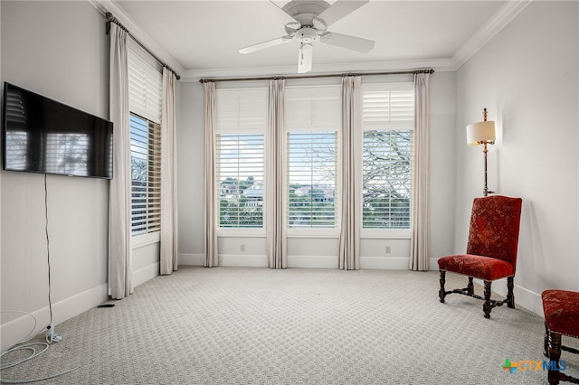 living area with plenty of natural light, carpet, crown molding, and a ceiling fan