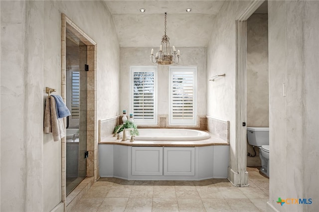 full bathroom featuring toilet, an inviting chandelier, a bath, and a stall shower