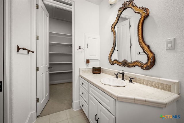 bathroom with tile patterned flooring and vanity