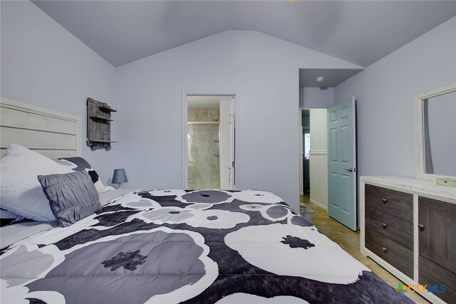 carpeted bedroom featuring lofted ceiling and connected bathroom