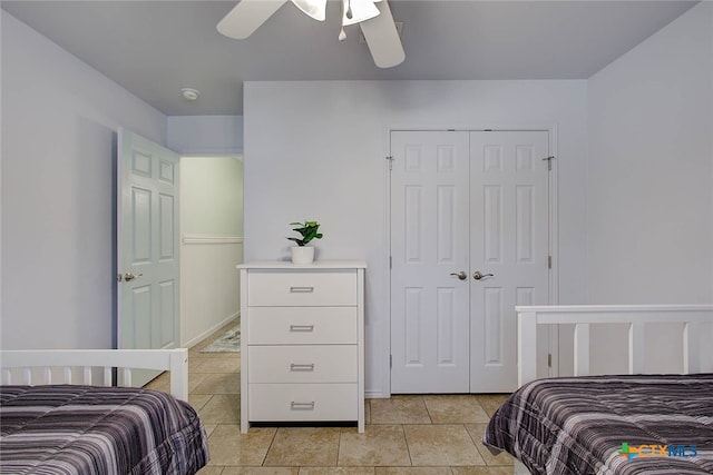 126 Breezy St, Rockport, TX 78382 - bedroom featuring a closet, light tile patterned floors, and a ceiling fan