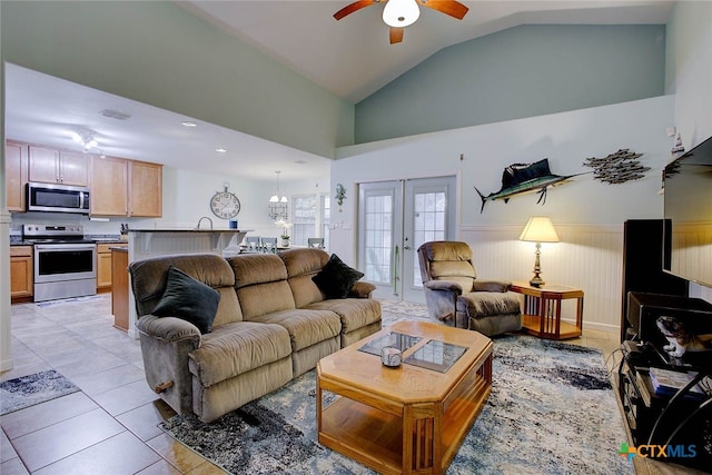 126 Breezy St, Rockport, TX 78382 - living area with wainscoting, a ceiling fan, lofted ceiling, light tile patterned floors, and french doors