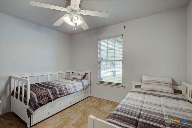 bedroom featuring ceiling fan and light tile patterned floors