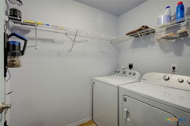 washroom with washing machine and clothes dryer