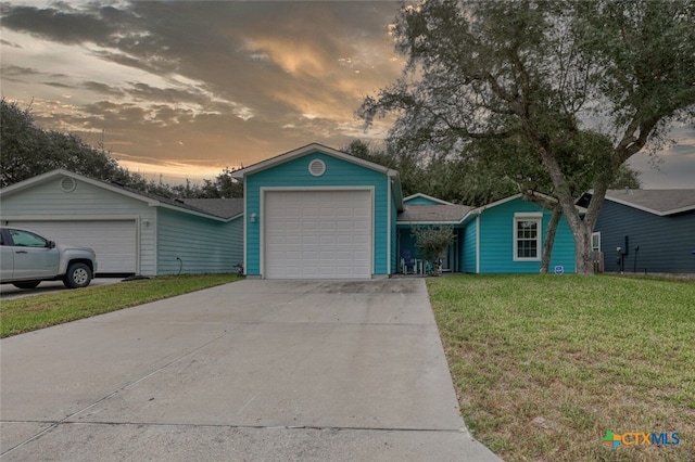 126 Breezy St, Rockport, TX 78382 - ranch-style house with a lawn, a detached garage, driveway, and roof with shingles