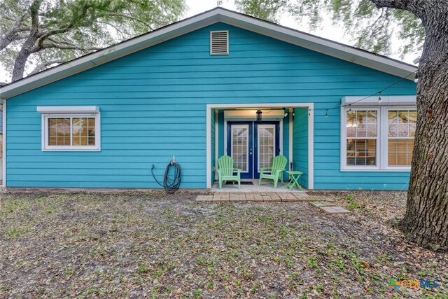 rear view of house featuring french doors