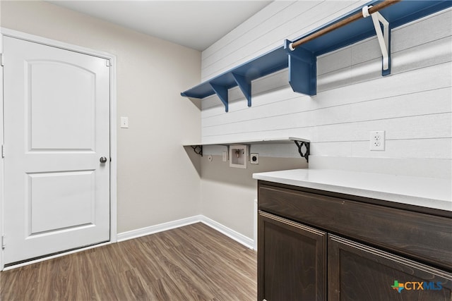 washroom featuring hookup for an electric dryer, hookup for a washing machine, cabinets, and hardwood / wood-style flooring