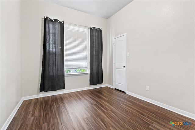 empty room with dark hardwood / wood-style floors