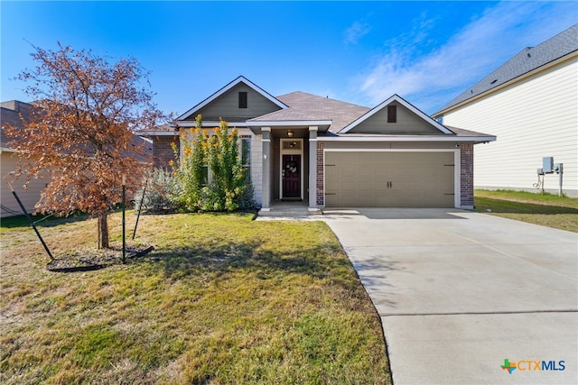 view of front of property featuring a garage and a front lawn