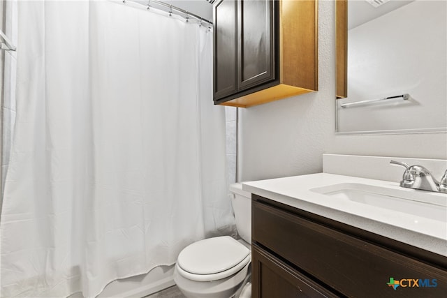 full bathroom featuring shower / bath combo, toilet, and vanity