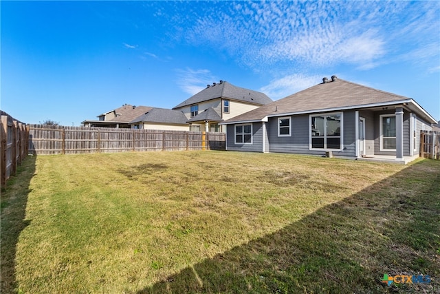 back of house with a lawn