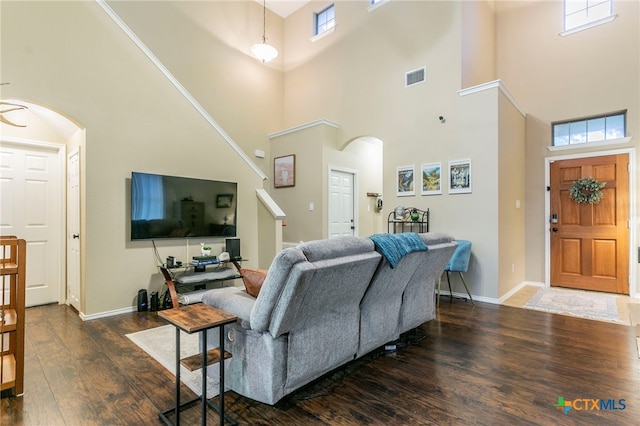 6707 Bayberry Dr, Killeen, TX 76542 - living area with arched walkways, wood finished floors, a high ceiling, and baseboards