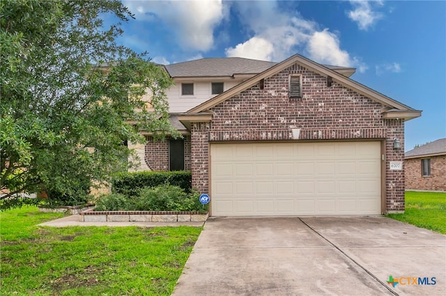 6707 Bayberry Dr, Killeen, TX 76542 - view of front of property featuring brick siding, concrete driveway, an attached garage, and a front lawn