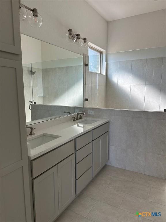 7217 Touchstone Dr, Temple, TX 76502 - bathroom with tile walls, double vanity, tiled shower, and tile patterned flooring