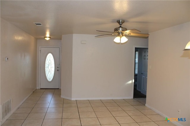 entryway featuring light tile patterned floors and ceiling fan