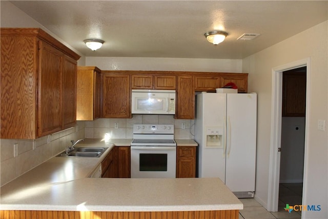 kitchen featuring kitchen peninsula, backsplash, white appliances, sink, and light tile patterned floors