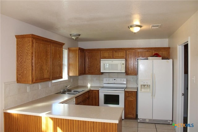 kitchen featuring white appliances, sink, tasteful backsplash, light tile patterned flooring, and kitchen peninsula