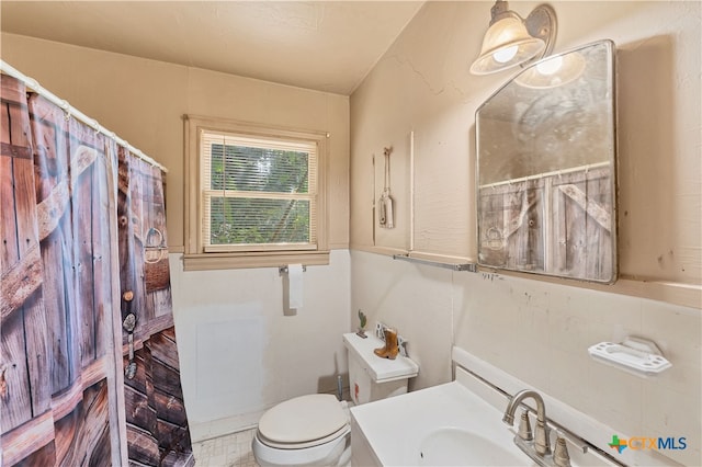 bathroom with a shower with curtain, vanity, toilet, and tile walls