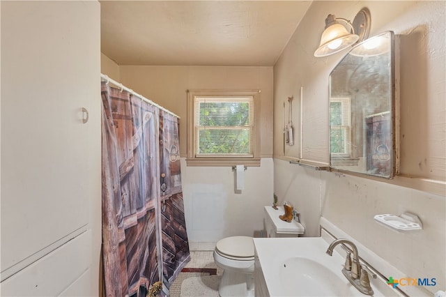 bathroom featuring vanity, tile patterned flooring, toilet, and a shower with curtain