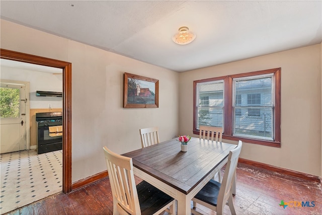 dining space with dark hardwood / wood-style floors