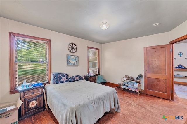 bedroom with hardwood / wood-style floors