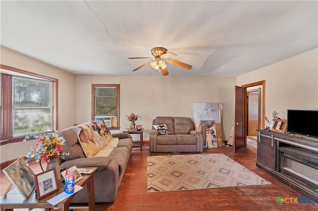 living room with dark hardwood / wood-style flooring, cooling unit, and ceiling fan