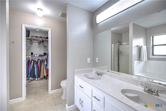 full bath with visible vents, a sink, a shower stall, and toilet