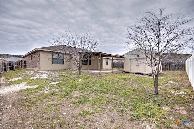 rear view of property with a patio area, a fenced backyard, a storage shed, and an outdoor structure