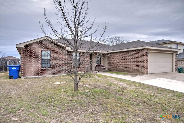 ranch-style home featuring an attached garage, driveway, a front lawn, and brick siding