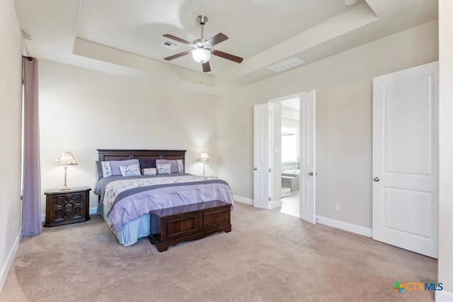 702 Old Settlers Dr, San Marcos, TX 78666 - carpeted bedroom with baseboards, a tray ceiling, and visible vents