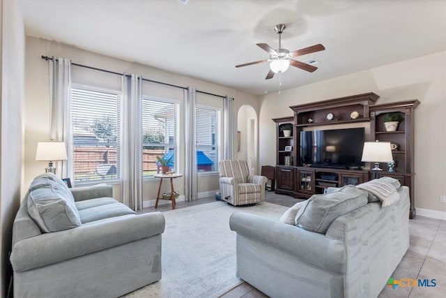702 Old Settlers Dr, San Marcos, TX 78666 - living area featuring a ceiling fan, arched walkways, baseboards, and light tile patterned floors