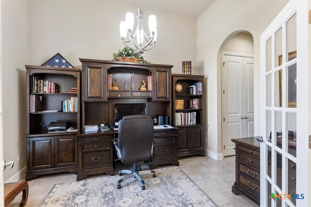 702 Old Settlers Dr, San Marcos, TX 78666 - office space with arched walkways, baseboards, a chandelier, and light tile patterned floors