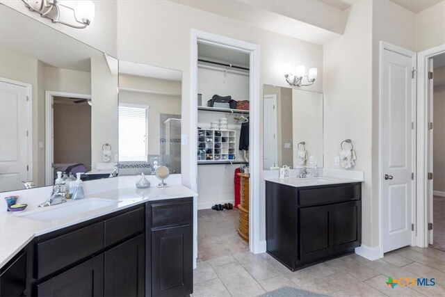 702 Old Settlers Dr, San Marcos, TX 78666 - full bath with a shower stall, a spacious closet, a sink, and two vanities
