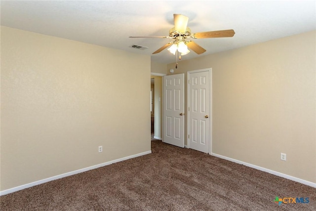 spare room featuring carpet flooring and ceiling fan