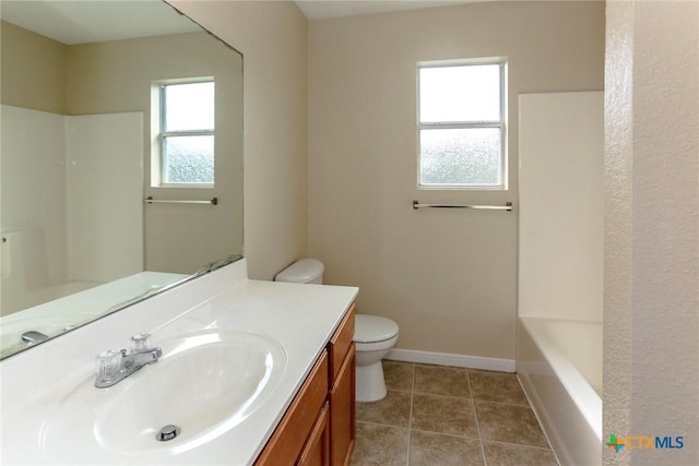 bathroom with tile patterned flooring, vanity, and toilet