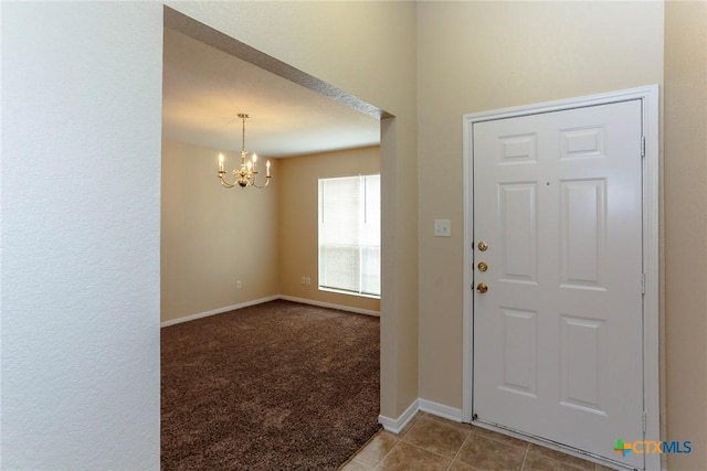 entryway featuring tile patterned floors and a notable chandelier