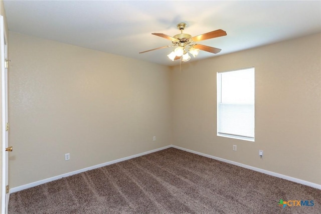 carpeted spare room featuring ceiling fan