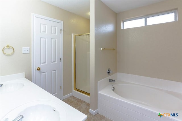 bathroom with shower with separate bathtub, tile patterned floors, and sink