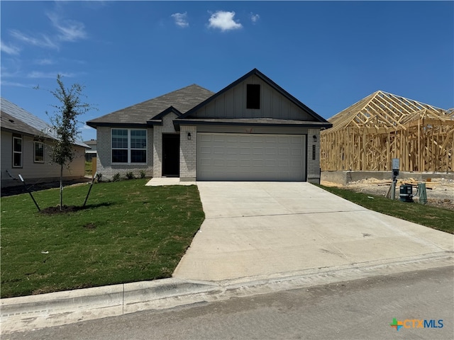 view of front of home with a garage and a front yard