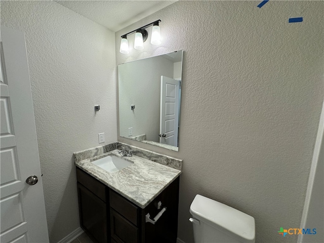 bathroom with toilet and vanity