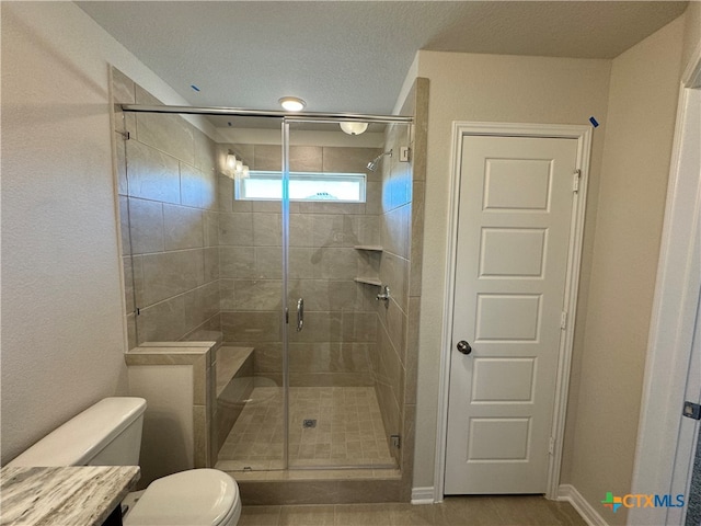 bathroom with walk in shower, tile patterned flooring, a textured ceiling, and toilet