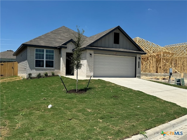 view of front of home featuring a garage and a front lawn