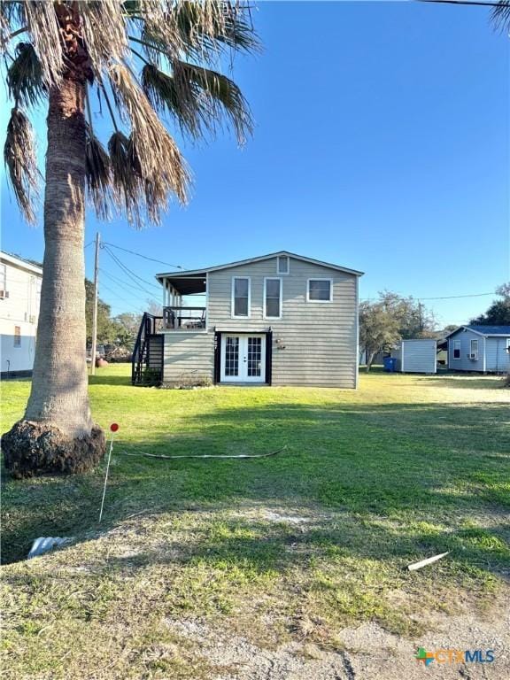 view of front of house with stairway and a front yard